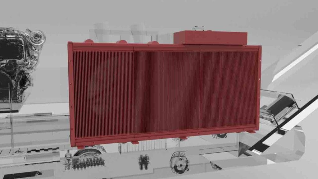 Large red industrial radiator/heat exchanger mounted in a grayscale workshop setting