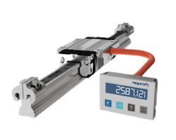 Digital force gauge connected to a metal testing rig with a display reading 258.12.